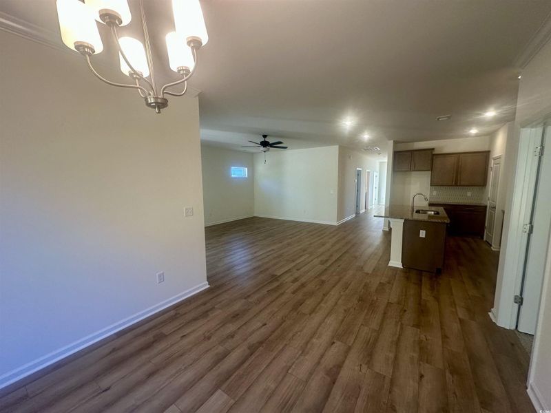 View from the Dining room with ceiling fan, dark wood-style floors, and a chandelier
