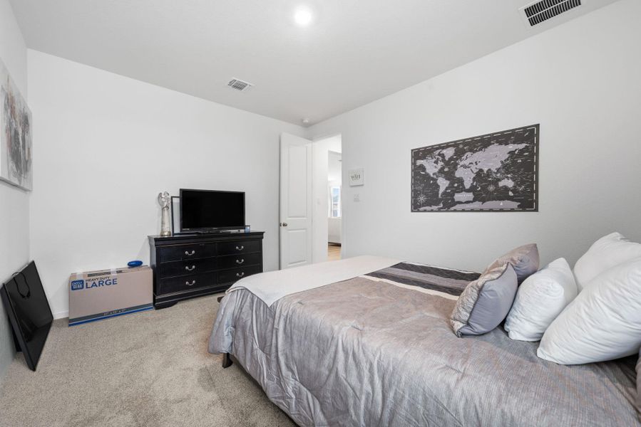 Bedroom with light carpet