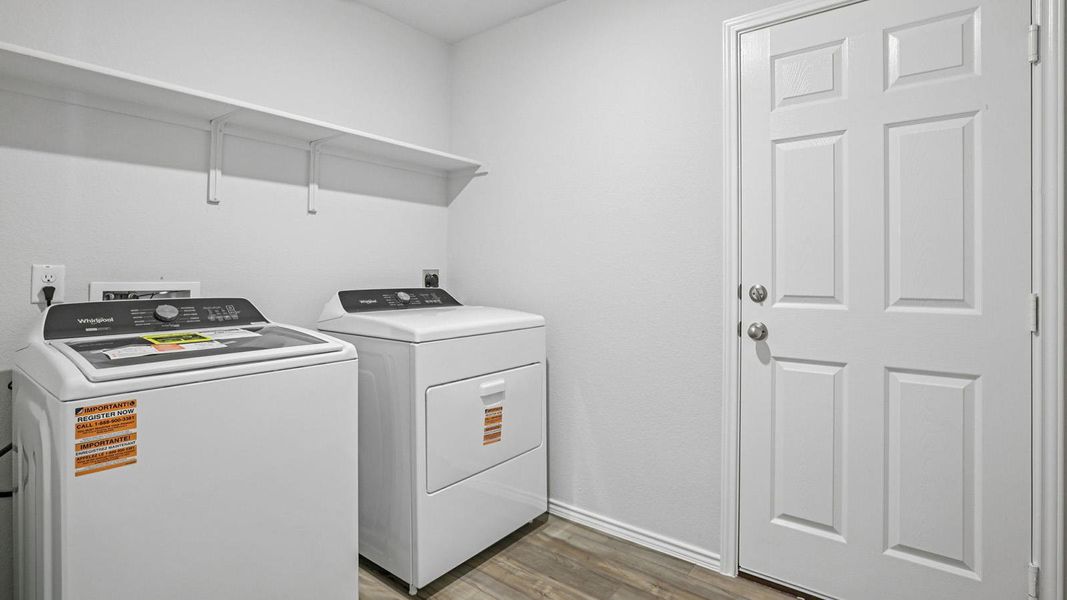 Laundry area with dark wood-style flooring and separate washer and dryer
