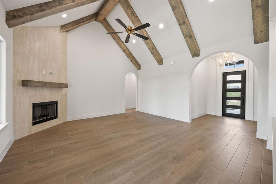 Vaulted ceiling featuring exposed wood beams and recessed lighting