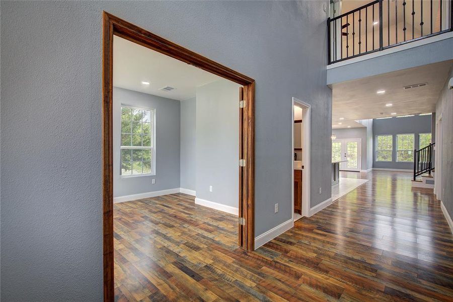 Corridor with office and half bath on the left