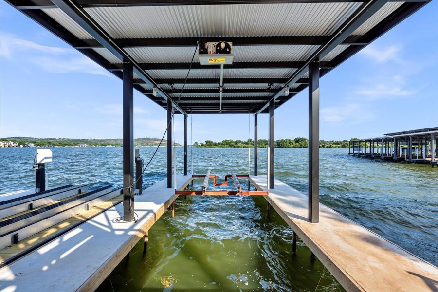 Dock area featuring a water view and boat lift