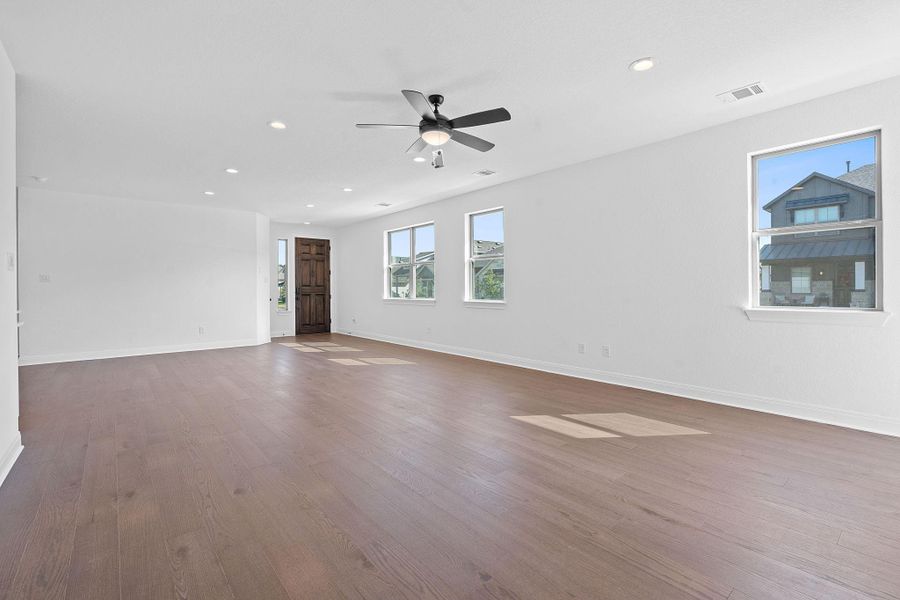 Unfurnished room with recessed lighting, wood finished floors, and a ceiling fan Unfurnished room with recessed lighting, wood finished floors, and a ceiling fan