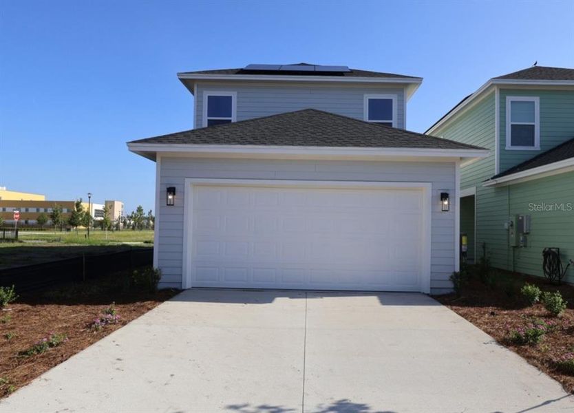 Front exterior of a new home in Weslyn Park in Sunbridge 34', St. Cloud, FL, highlighting curb appeal (Image 2). Front exterior of a new home in Weslyn Park in Sunbridge 34', St. Cloud, FL, highlighting curb appeal (Image 2).