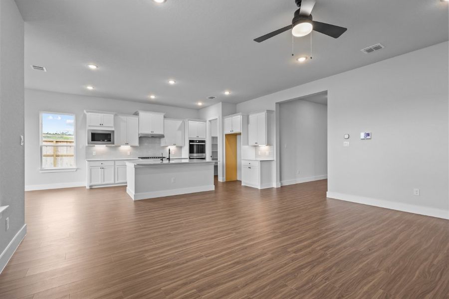 A large kitchen with white cabinets. A large kitchen with white cabinets.