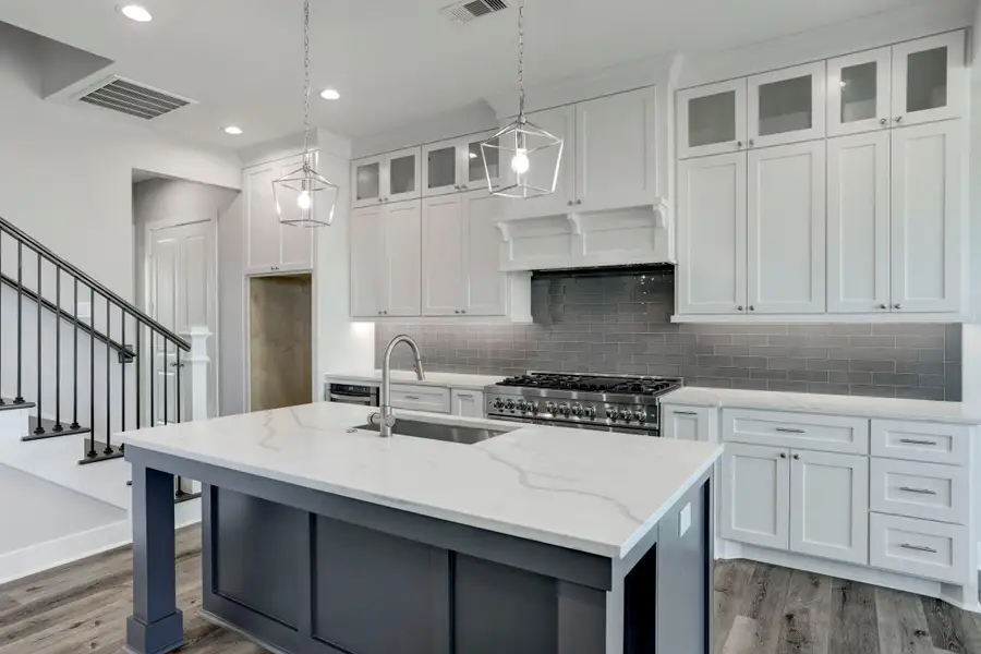 Quartz kitchen island offers a breakfast bar with room for bar stools. Quartz kitchen island offers a breakfast bar with room for bar stools.