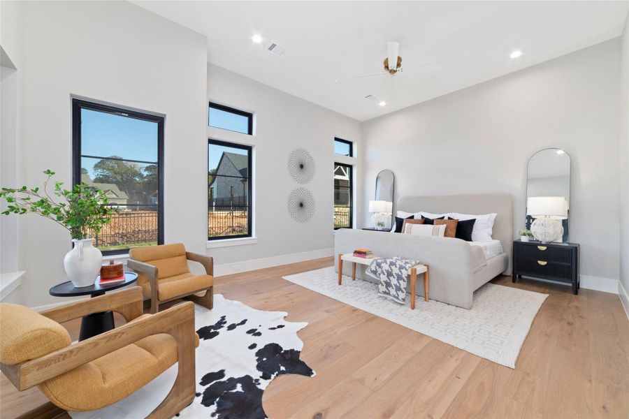 Expansive primary bedroom with modern finishes and abundant light.