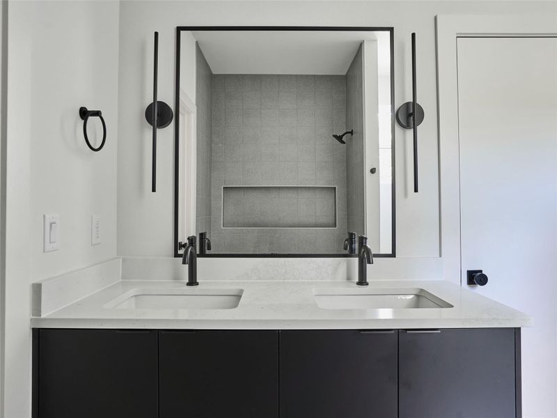 Bathroom featuring double vanity and a shower Bathroom featuring double vanity and a shower