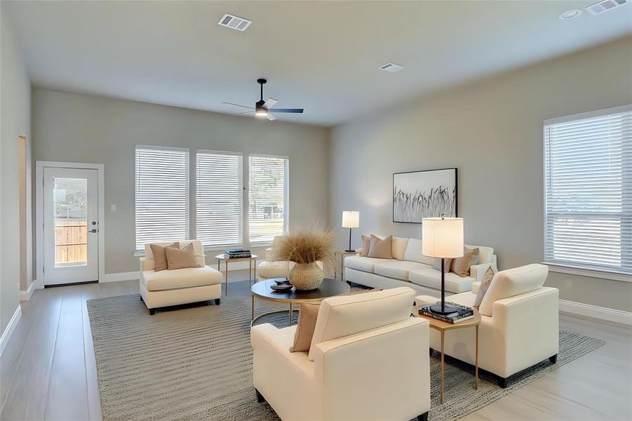 Living area featuring baseboards and ceiling fan Living area featuring baseboards and ceiling fan