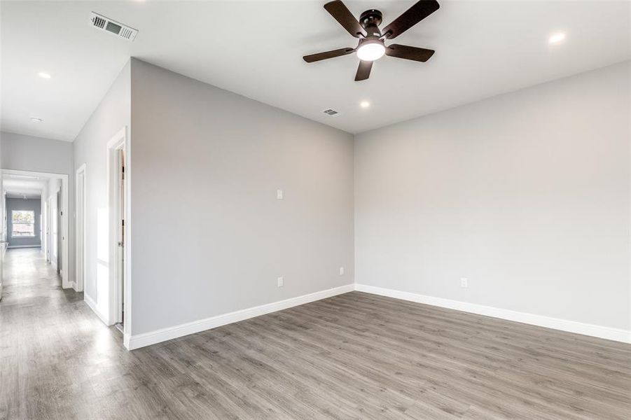 Unfurnished room featuring ceiling fan and light wood-type flooring