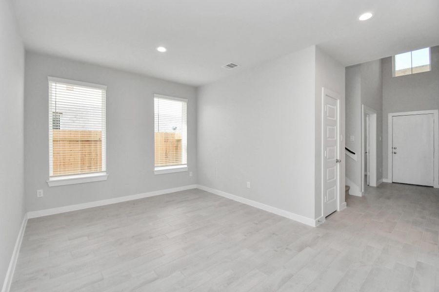 Make memories gathered around the table with your family and friends! This spacious dining room features elegant flooring, custom paint, and adjacent to family room and kitchen for open concept feel. Sample photo of completed home with similar floor plan. Actual colors and selections may vary.