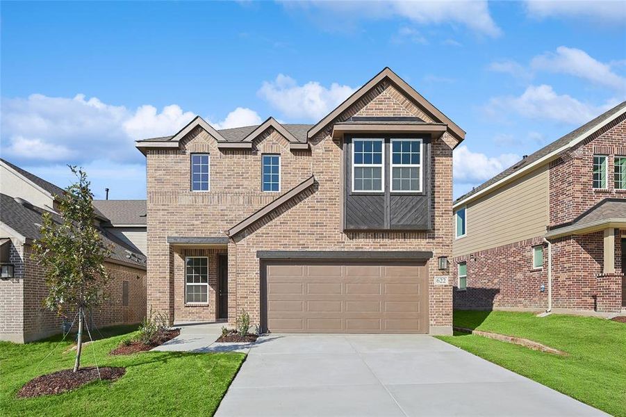 View of front of home with a garage and a front lawn