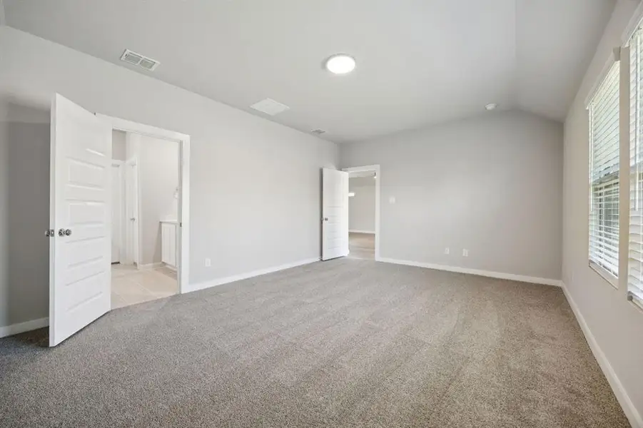 Primary Suite in the Oscar home plan by Trophy Signature Homes – REPRESENTATIVE PHOTO