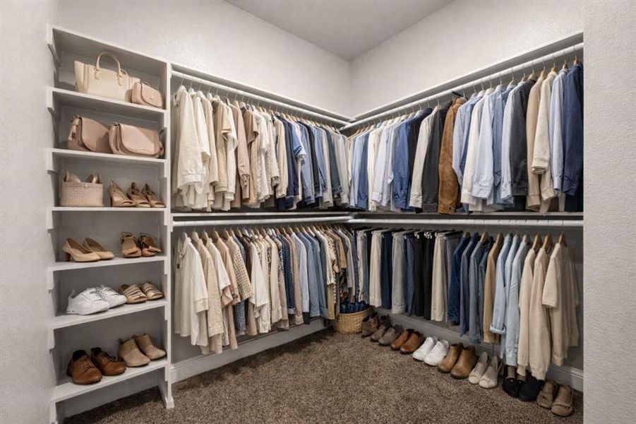 Walk in closet featuring dark carpet