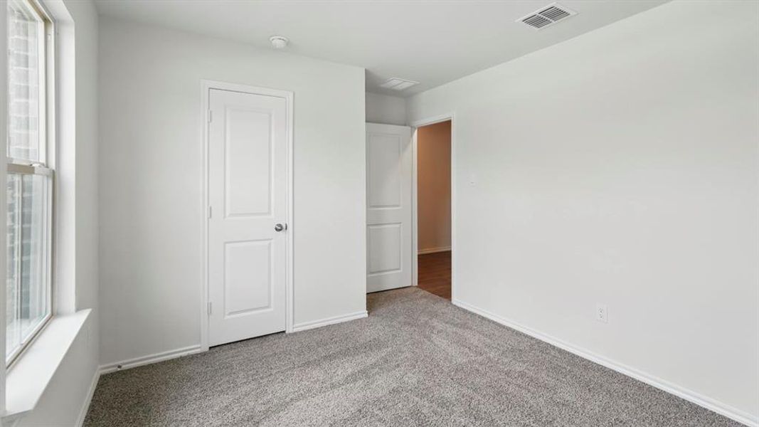 Interior room with neutral gray carpeting and white walls