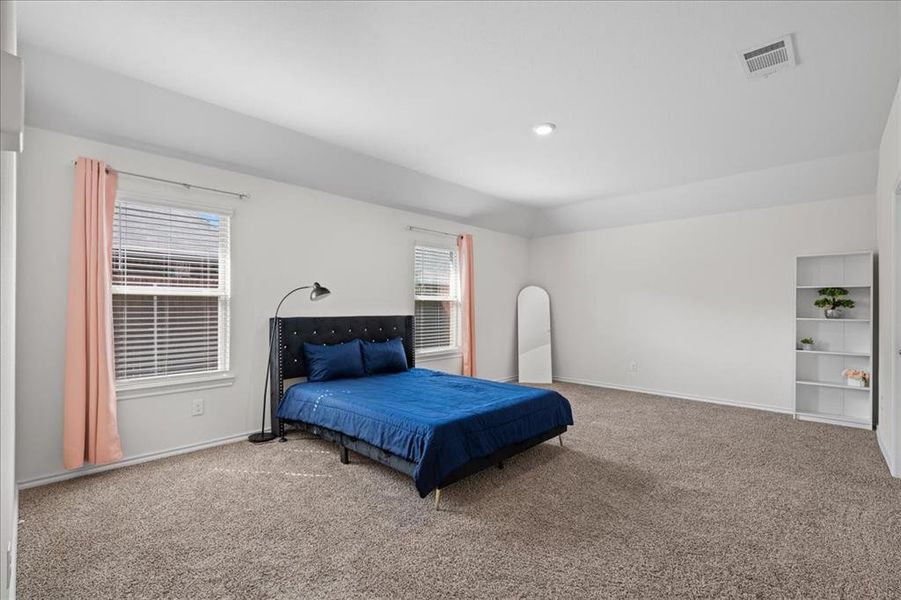 Carpeted bedroom with baseboards and recessed lighting Carpeted bedroom with baseboards and recessed lighting