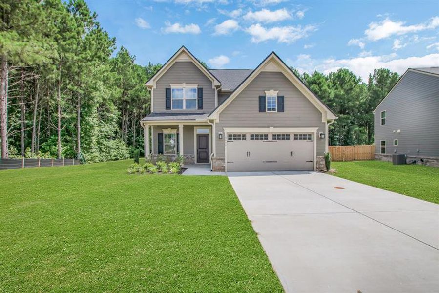 Front exterior of a new home in Southern Hills, McDonough, GA, highlighting curb appeal (Image 1). Front exterior of a new home in Southern Hills, McDonough, GA, highlighting curb appeal (Image 1).