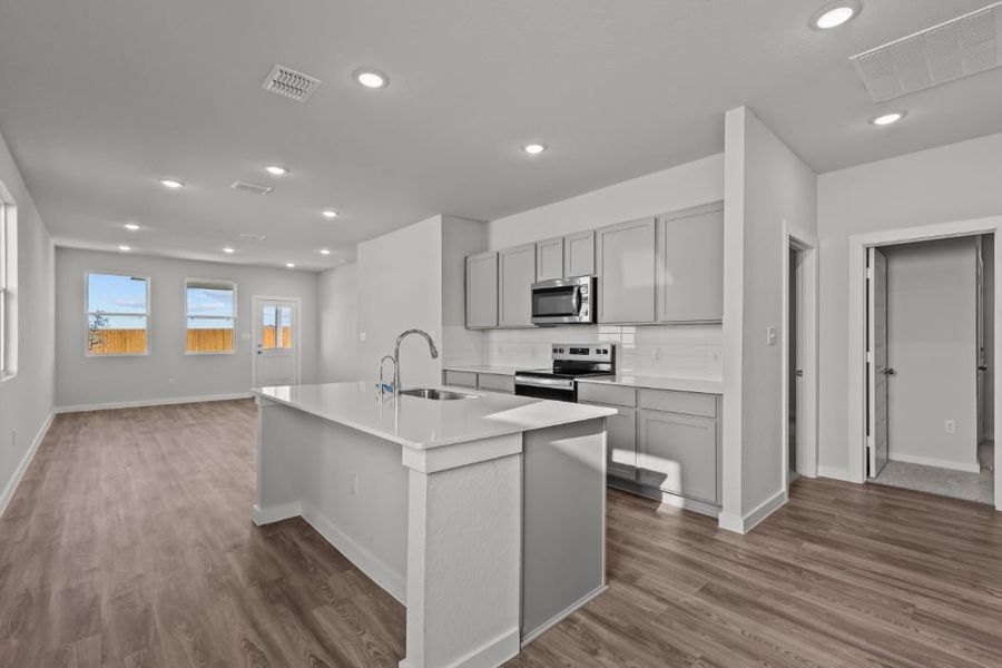 A kitchen with white cabinets.