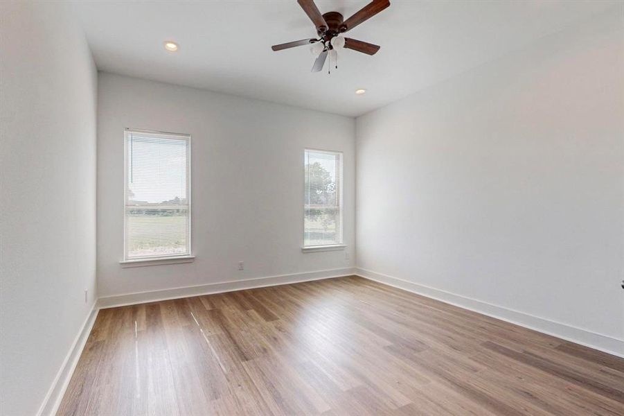 Spare room featuring hardwood / wood-style floors and ceiling fan