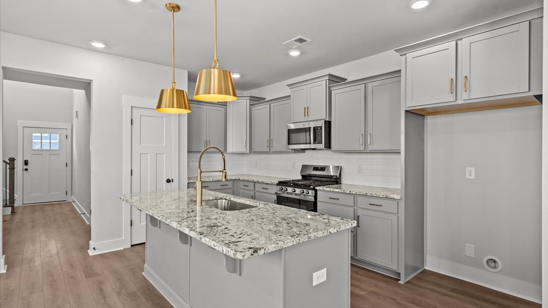 First-class kitchen with a spacious 7-foot island—perfect for entertaining beneath designer pendant lighting