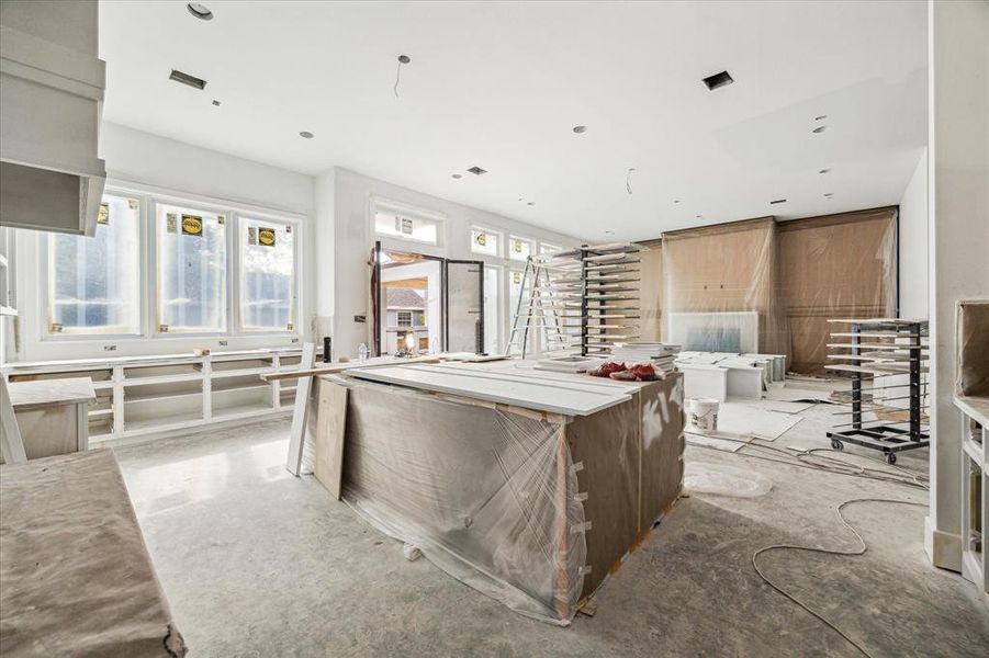 Statement island with waterfall countertop.  This kitchen has a ton of storage and countertop space, including the buffet space to the left of the photo with backyard views.  Your best entertaining awaits.  Construction as of 10/29