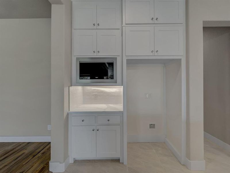 Kitchen featuring white cabinets and light countertops Kitchen featuring white cabinets and light countertops