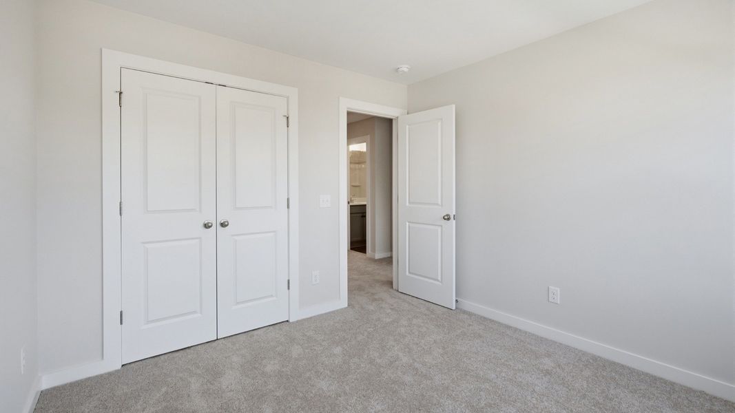 Separate secondary bedroom with double door closet for storage options