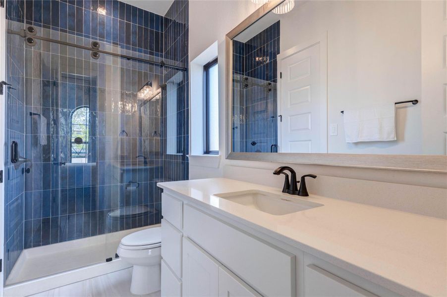 This cozy bedroom features a high ceiling and a neutral palette, complete with a comfortable double bed, matching wooden nightstands, and a dresser. An ensuite bathroom with modern fixtures is accessible through an adjacent door. This cozy bedroom features a high ceiling and a neutral palette, complete with a comfortable double bed, matching wooden nightstands, and a dresser. An ensuite bathroom with modern fixtures is accessible through an adjacent door.