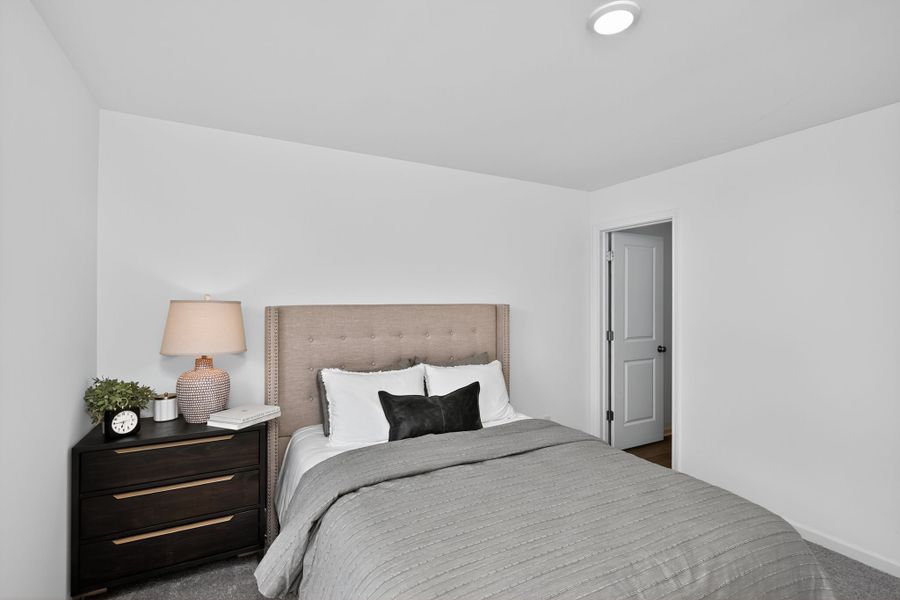 A bed with a lamp on the side.