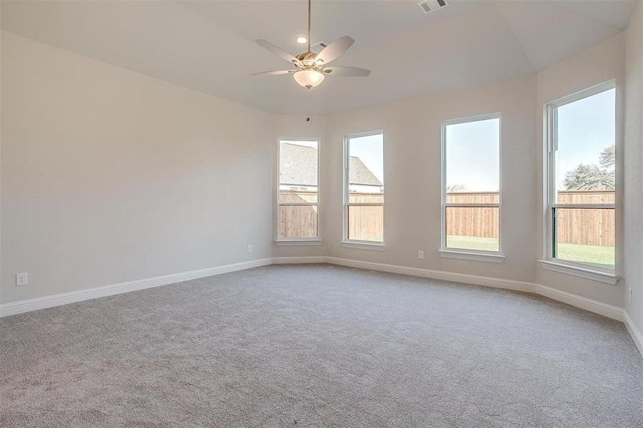 Unfurnished room with ceiling fan and light carpet