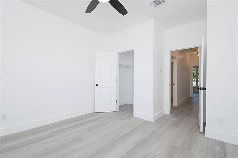 Unfurnished bedroom featuring light wood-style flooring and ceiling fan