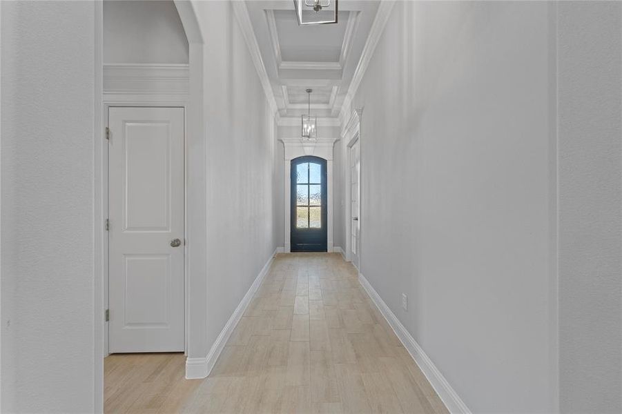 Corridor featuring ornamental molding and light wood-type flooring