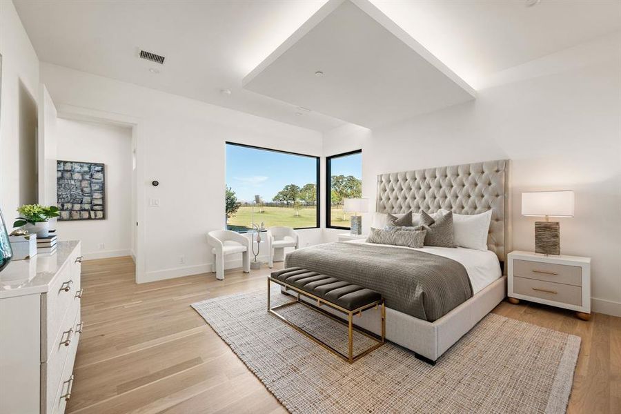 Primary bedroom with seating area and expansive views. Primary bedroom with seating area and expansive views.