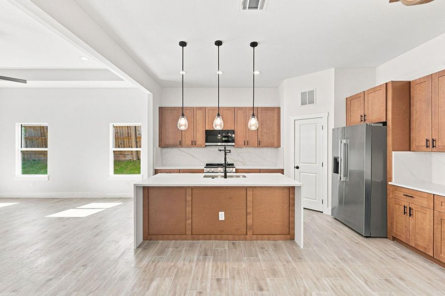 Warm, natural wood-toned shaker cabinets offering extensive storage and a timeless aesthetic.