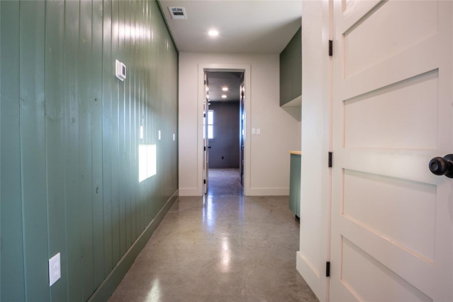 Hall featuring finished concrete floors and recessed lighting