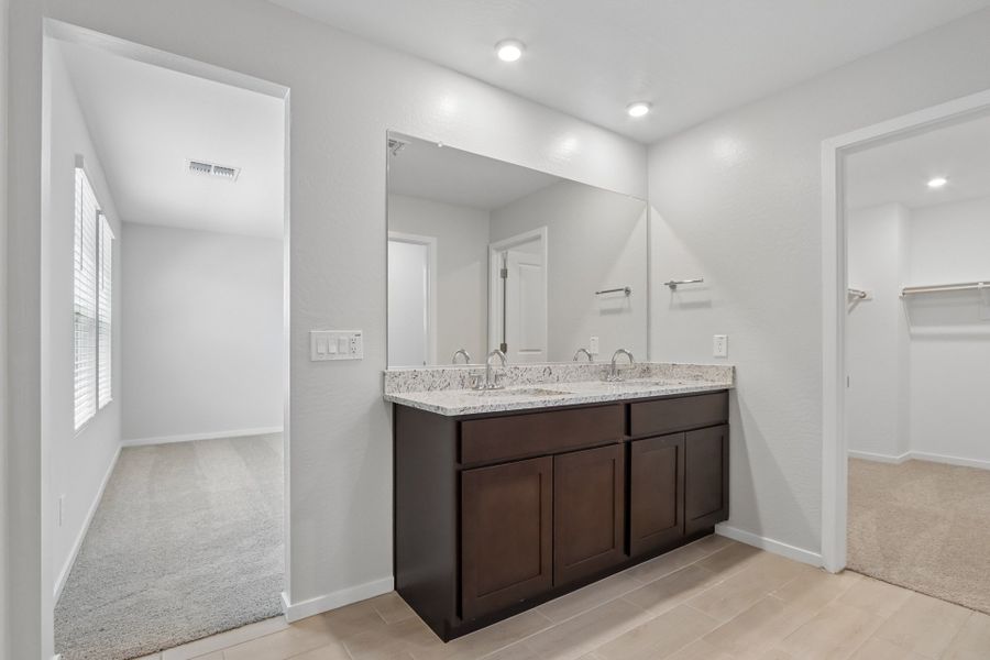 A bathroom with a large mirror.