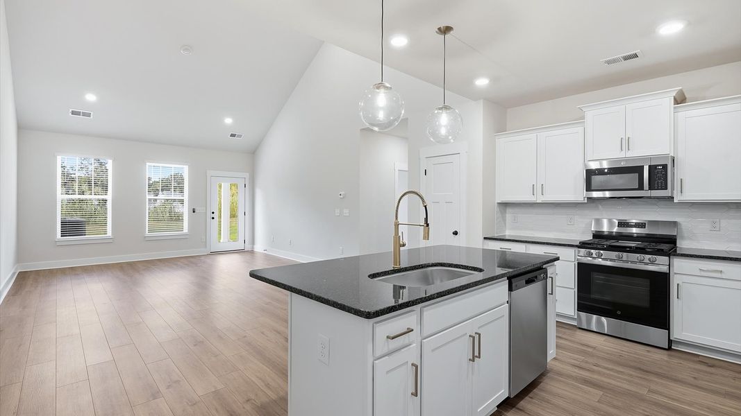 Expansive kitchen offering exceptional workspace and effortless flow to adjacent living areas by DRB Homes Expansive kitchen offering exceptional workspace and effortless flow to adjacent living areas by DRB Homes