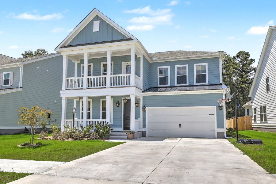 Front exterior of a new home in Tidewater at Lakes of Cane Bay, Summerville, SC, highlighting curb appeal (Image 2). Front exterior of a new home in Tidewater at Lakes of Cane Bay, Summerville, SC, highlighting curb appeal (Image 2).