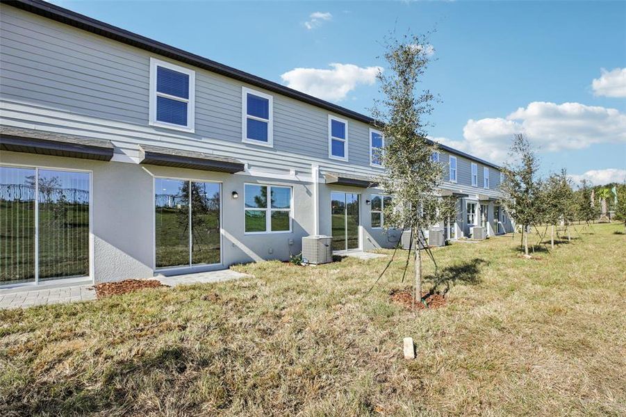 Exterior details and patio area of a home in The Reserve at Hammock Oaks Townes, Lady Lake (Image 23).