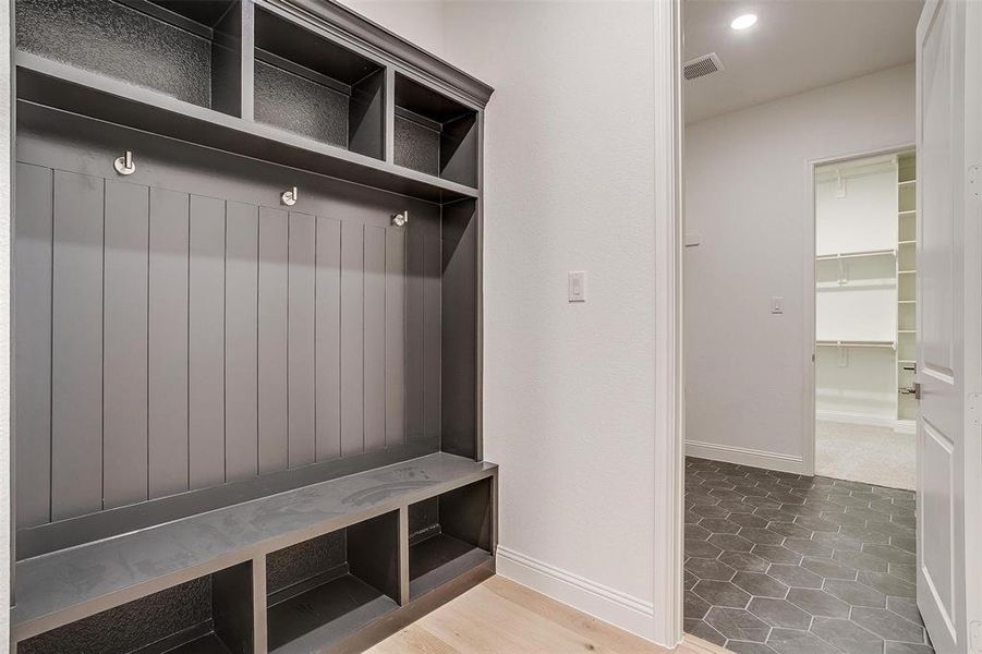 Mudroom featuring built ins and tile  floors