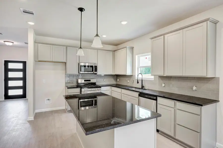 The Davenport II- Kitchen. Home under construction. Sample floor plan photo used for illustrative purposes only. Upgrades, selections options, windows and colors may vary. The Davenport II- Kitchen. Home under construction. Sample floor plan photo used for illustrative purposes only. Upgrades, selections options, windows and colors may vary.