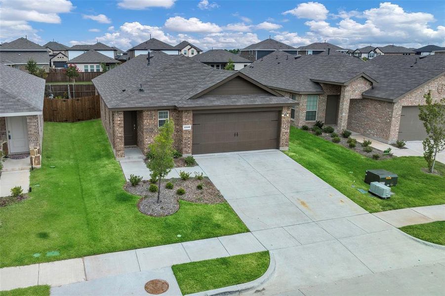 View of front of house featuring a garage and a front yard