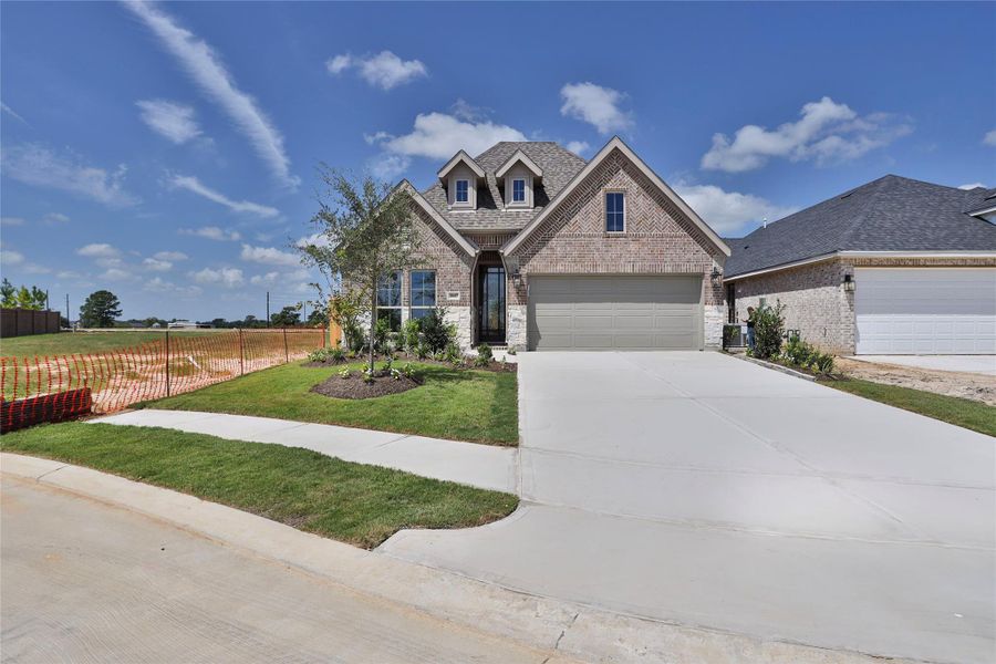 Front exterior of a new home in Everly, Hockley, TX, highlighting curb appeal (Image 2).