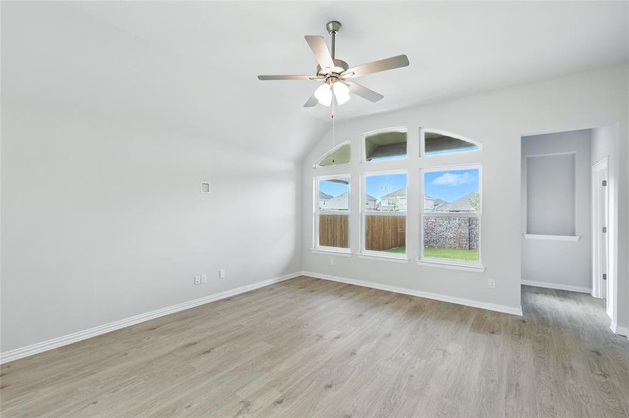 Unfurnished living room featuring light wood finished floors, recessed lighting, a ceiling fan, and lofted ceiling Unfurnished living room featuring light wood finished floors, recessed lighting, a ceiling fan, and lofted ceiling