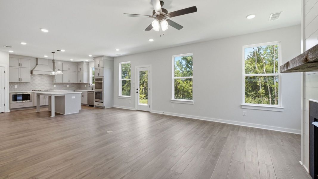 Gathering room with view of kitchen and access to rear entry