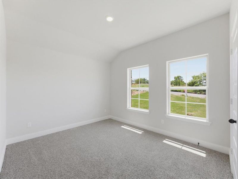 Carpeted room with vaulted ceilings and recessed lighting Carpeted room with vaulted ceilings and recessed lighting