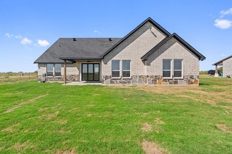 Back of property with a patio area and a lawn