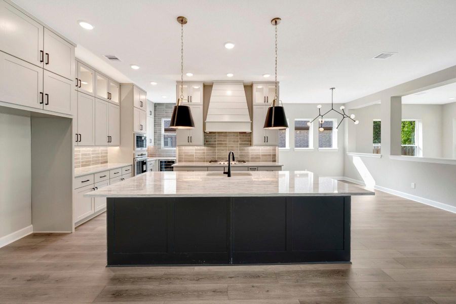 This Kitchen is a real showstopper with gorgeous Quartz counters, updraft vent hood in a unique vent cabinet, cabinets that soar to the ceiling with self closing doors/drawers plus a 5 burner gas c-top & separate oven/micro.