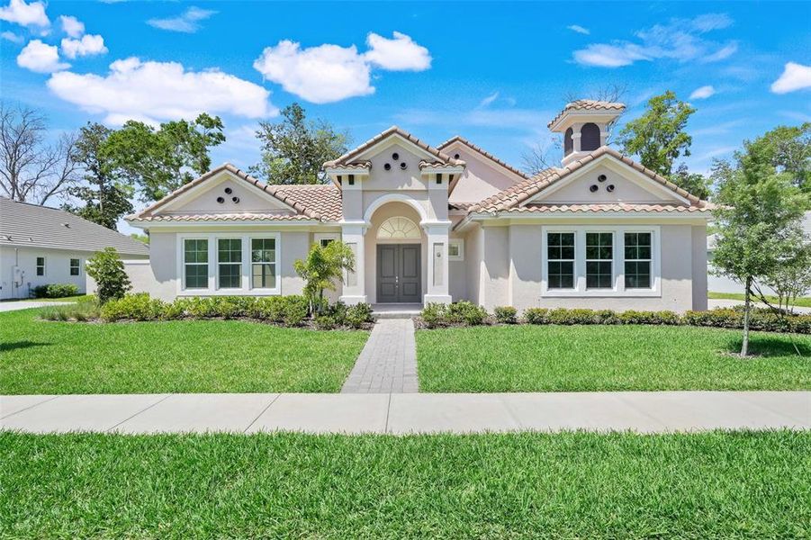 Front exterior of a new home in Toscana, Palm Coast, FL, highlighting curb appeal (Image 22).