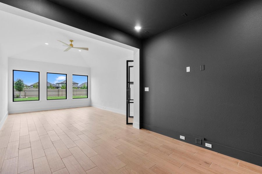 The spacious game room connects to a media room. Representative image.